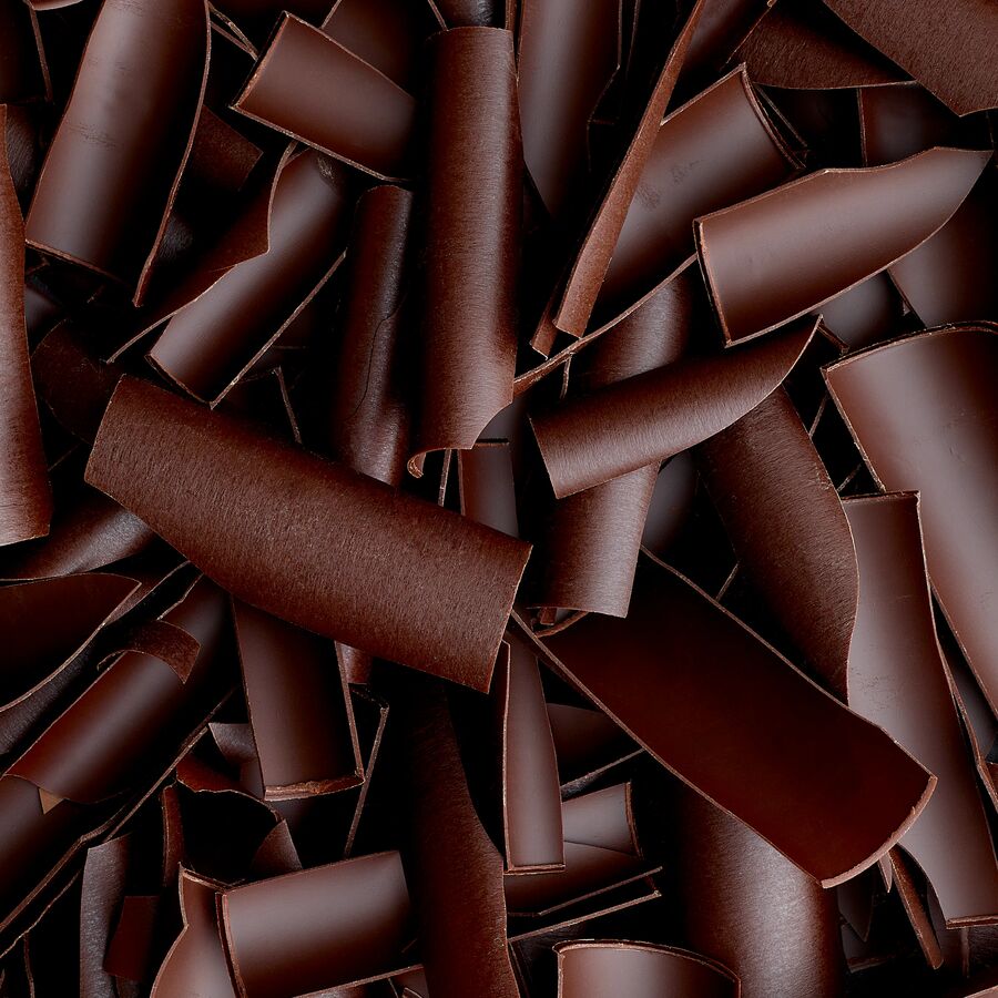 A close-up image of dark chocolate shavings.